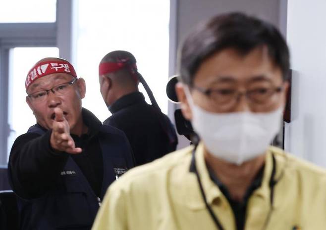 김명섭 화물연대본부 전북지역본부장이 지난달 30일 정부세종청사 국토교통부에서 열린 2차 교섭이 결렬되자 자리를 뜨는 구헌상 국토부 물류정책관에게 항의하고 있다. 윤석열 대통령은 사상 최초로 화물차 노동자에 대해 업무개시명령을 발동했다. 연합뉴스