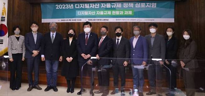 12일 국회도서관 소회의실에서 열린 ‘디지털자산 자율규제 정책 심포지엄’에서 참석자들이 기념촬영을 하고 있다. 사진=손희정 기자