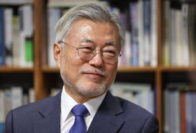 경남 양산시 하북면 평산마을 사저에 앉아 있는 문재인 전 대통령 뒤로 책장에 꽃힌 책들이 보인다. 더불어민주당 제공