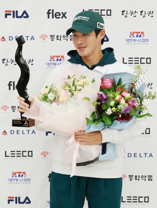 한국 선수 최초로 ATP 투어 단식에서 두 번 우승한 권순우가 지난 18일 인천국제공항 제2여객터미널을 통해 귀국해 트로피를 들고 취재진을 향해 포즈를 취하고 있다.[사진 연합뉴스]