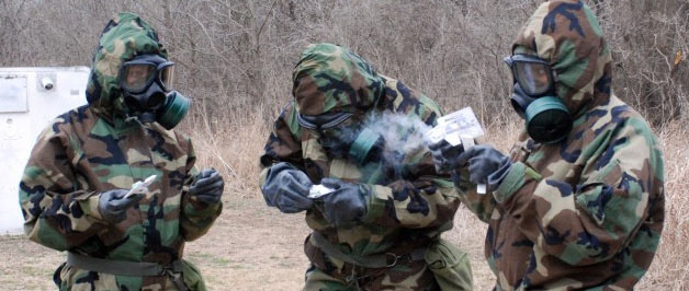 방호복을 입은 한 무리의 병사들이 들판에서 훈련에 대비하고 있다. 최근 캐나다 연구진은 특수 화학물질을 함유한 의복을 만들어 세탁 없이도 위생 상태를 유지할 수 있는 기술을 개발했다. 미국 육군 제공
