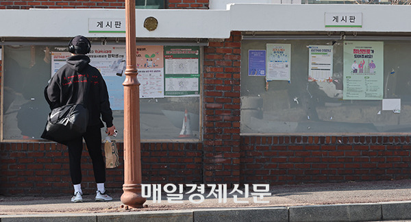 A student is looking at the bulletin boards on campus. [Photo by Lee Seung-hwan]