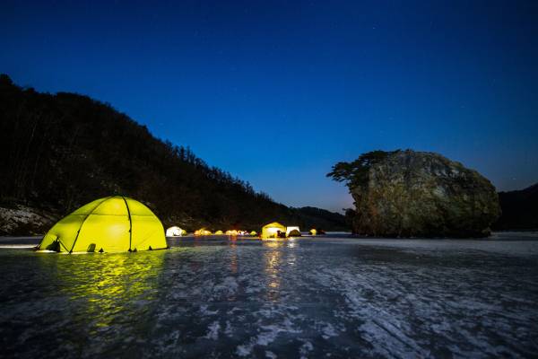 강원도 홍천군 서면 모곡밤벌유원지 인근 배바위 옆 꽁꽁 얼어붙은 홍천강 위에서 ‘빙박’하는 캠퍼들이 겨울 낭만을 즐기고 있다. 어둠이 찾아들면 맑은 밤하늘엔 별이 보석처럼 반짝이고 불 밝힌 텐트는 얼음에 환상적인 반영을 펼쳐놓는다.
