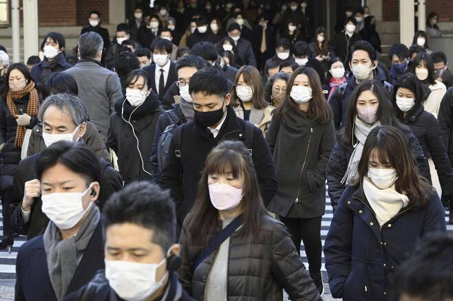 일본 도쿄역 근처에서 마스크를 쓴 시민들이 출근하고 있다./연합뉴스