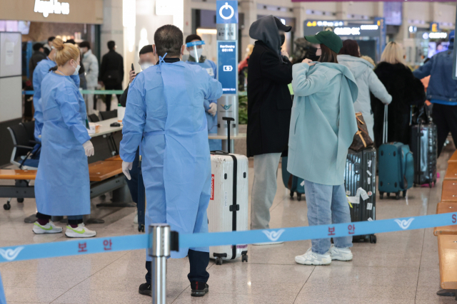 10일 인천국제공항 제1여객터미널에서 중국발 입국자들이 의료진 안내를 받고 있다. /연합뉴스