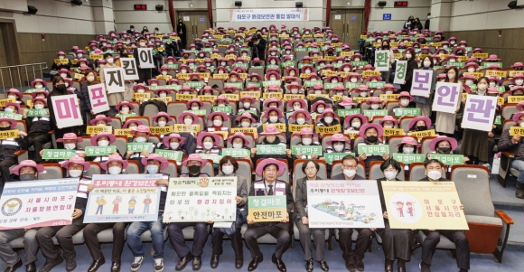 박강수(앞줄 오른쪽 다섯 번째) 서울 마포구청장이 지난달 31일 구청에서 열린 ‘우리동네 환경보안관’ 통합 발대식에서 환경보안관에 참여하는 어르신들과 기념사진을 촬영하고 있다. 마포구 제공