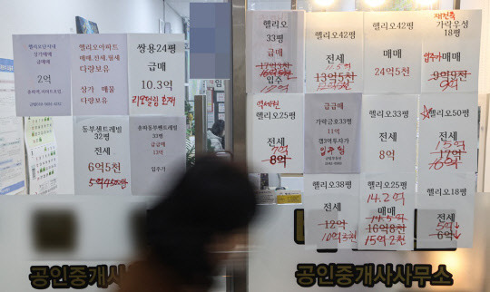 서울 시내 한 상가 공인중개사 사무소에 붙은 손글씨로 가격정보를 수정한 광고지들.<연합뉴스>