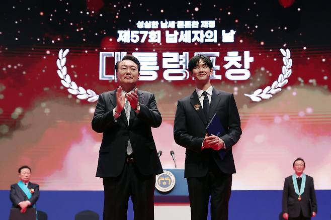윤석열 대통령이 3일 서울 강남구 코엑스에서 열린 제57회 납세자의 날 기념식에서 모범납세자로 선정된 배우 김수현에게 대통령표창을 수여한 뒤 축하하고 있다. 대통령실 제공