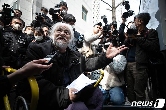 박경석 전국장애인차별철폐연대(전장연) 대표가 17일 오전 서울 종로구 서울지방경찰청 앞에서 법원의 체포영장 발부에 따른 입장발표 기자회견을 마치고 경찰 호송차에 오르기 전 취재진의 질문에 답하고 있다.  2023.3.17/뉴스1 ⓒ News1 이승배 기자