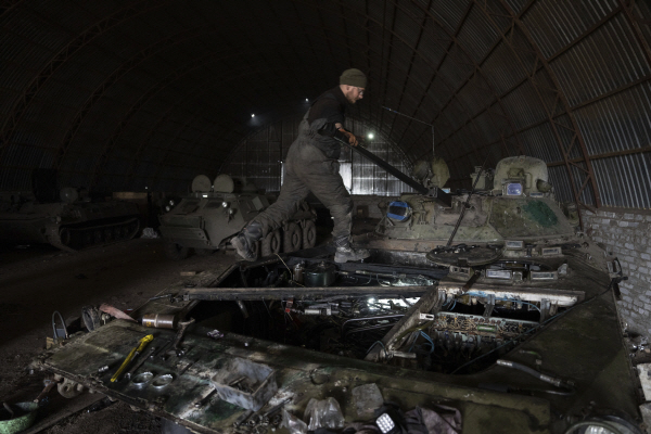 우크라이나군이 18일(현지 시간) 도네츠크 지역의 최전선에서 멀지 않은 임시 기지에서 기계를 수리하고 있다. (AP=연합뉴스)