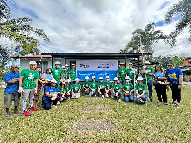 Employees from Korean Air, Delta Air Lines and Habitat for Humanity Philippines pose for a photo after a home repairing event in Calauan, the Philippines, on March 17. (Korean Air)