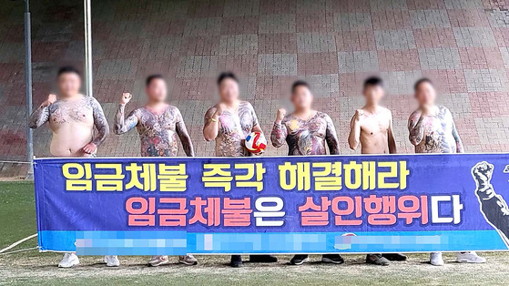 Members of a gang in Incheon pose together with a banner that demands payment for their supposed labor at construction sites. [GYEONGGI NAMBU PROVINCIAL POLICE AGENCY]