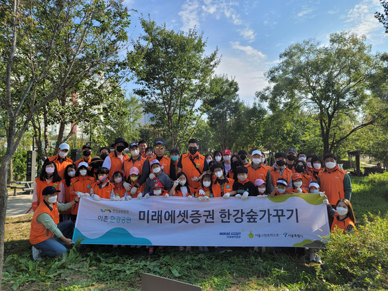 Mirae Asset Securities employees pose along the Han River. [MIRAE ASSET SECURITIES]