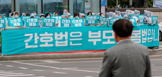 대한간호협회와 시민단체 회원들이 25일 서울 영등포구 국회 앞에서 열린 간호법 국회 통과 촉구 문화마당에서 간호법 제정이 적힌 피켓을 들어 보이고 있다. 뉴스1