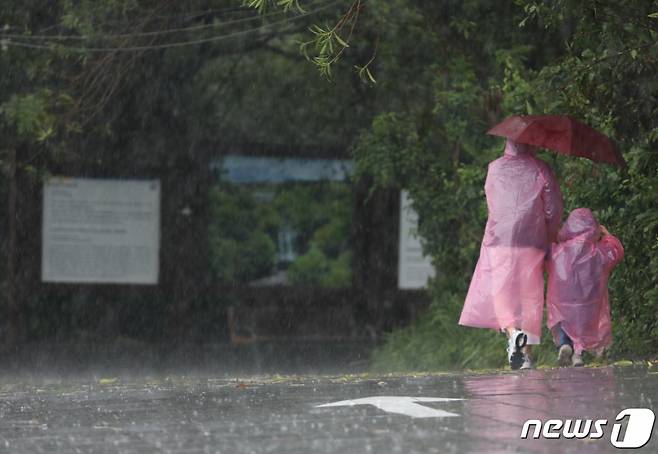 호우·강풍특보가 발효 중인 4일 오후 제주 서귀포시 한 관광지 주차장에서 모녀가 비를 피하며 걷고 있다. /사진=뉴스1