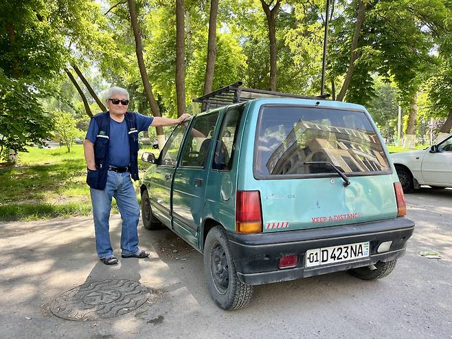 Vladimir Kim, a Koryoin or ethnic Korean in Uzbekistan, stands next to his car as he poses for photo. (Kim Arin/The Korea Herald)