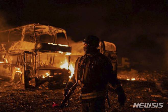 In this photo provided by the Ukrainian Emergency Situations Ministry, firefighters put out fire caused by fragments of a Russian rocket after it was shot down by air defense system during the night Russian rocket attack in Kyiv, Ukraine, early Tuesday, May 16, 2023. (Ukrainian Emergency Situations Ministry via AP)