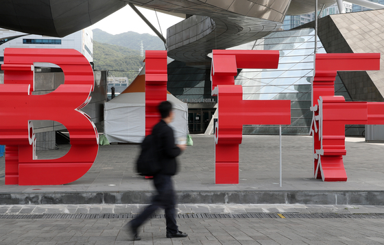 A passerby walks across the Busan International Film Festival (BIFF) logo in front of the Busan Cinema Center in Haeundae District, eastern Busan, on Wednesday. [YONHAP]