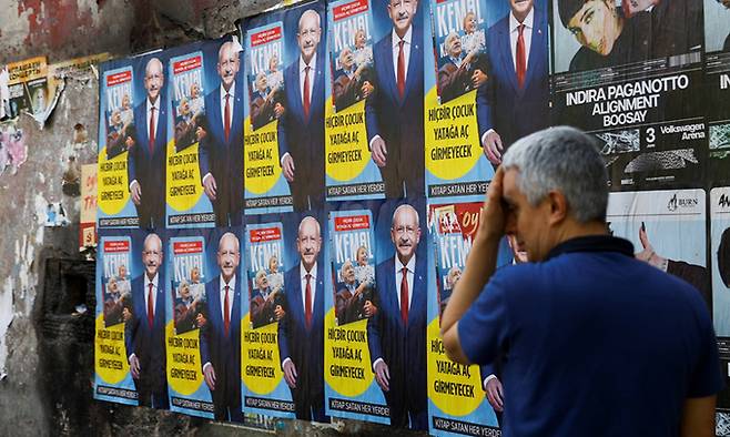 튀르키예 대선 결선투표를 이틀 앞둔 지난 26일(현지시간) 이스탄불에서 한 주민이 야당 단일 후보인 공화인민당(CHP) 케말 클르츠다로을루 대표의 포스터를 지나치고 있다. 로이터연합뉴스