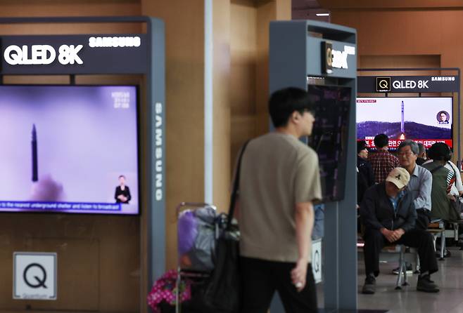 A commuter watches a TV report at Seoul Station, in the center of the capital, about North Korea's firing of what it claims to be a "space launch vehicle" southward on May 31, 2023. The Joint Chiefs of Staff said it detected the launch from Dongchang-ri on the North's west coast at 6:29 a.m., and the projectile flew over the waters far west of the South's border island of Baengnyeong. (Yonhap)