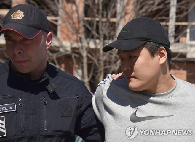 epa10540912 Police officers escort South Korean crypto mogul Do Kwon (R) in Podgorica, Montenegro, 24 March 2023. Do Kwon is wanted in South Korea, Singapore and the USA for the involvement in the collapse of his company Terraform, which is estimated to have cost investors more than 40 billion US dollars. EPA/BORIS PEJOVIC