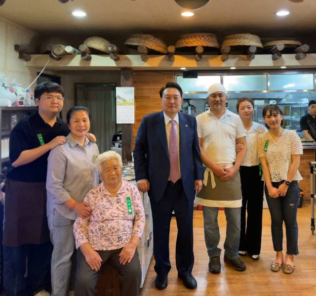 ▲ 9일 춘천을 찾은 윤석열 대통령이 오찬을 마치고, 춘천 샘밭막국수 조성종(54)대표 및 가족들과 함께 기념촬영을 했다.(사진 제공=샘밭막국수)