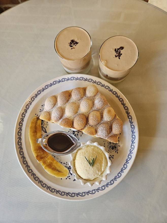 The banana and Nutella waffle with black tea-cream coffee at Iksun Jutaek in Ikseon-dong, Seoul (Park Yuna/The Korea Herald)