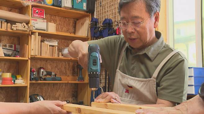 '접이식 책꽂이' 만드는법을 가르치고 있는 김성욱목사
