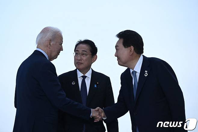 윤석열 대통령과 조 바이든 미국 대통령(맨좌측), 기시다 후미오 일본 총리(가운데)가 21일 히로시마 주요 7개국(G7) 정상회의를 계기로 히로시마에서 열리는 3국 정상회담을 위해 만나 인사를 나누고 있다. ⓒ AFP=뉴스1 ⓒ News1 이동원 기자