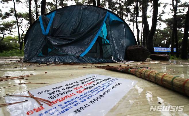 [제주=뉴시스] 우장호 기자 = 장맛비가 내리는 30일 오후 제주시 한림읍 금능해수욕장 인근 야영장에 사용자가 없는 이른바 '알박기' 텐트가 설치돼 있다. 제주시는 시민과 관광객이 효율적으로 해수욕장과 야영장을 사용할 수 있도록 7월1일부터 8월31일까지 협재·금능 청년회에 한시적으로 운영을 위탁해 유료화할 계획이다. 2023.06.30. woo1223@newsis.com