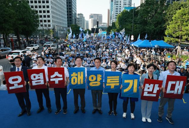 이재명 대표(왼쪽 네 번째부터)와 박광온 원내대표 등 더불어민주당 지도부가 1일 오후 서울 중구 숭례문 일대에서 열린 '일본 후쿠시마 원전 오염수 해양투기 규탄 범국민대회'에서 손팻말을 든 채 무대에서 상징의식을 펼치고 있다. 연합뉴스