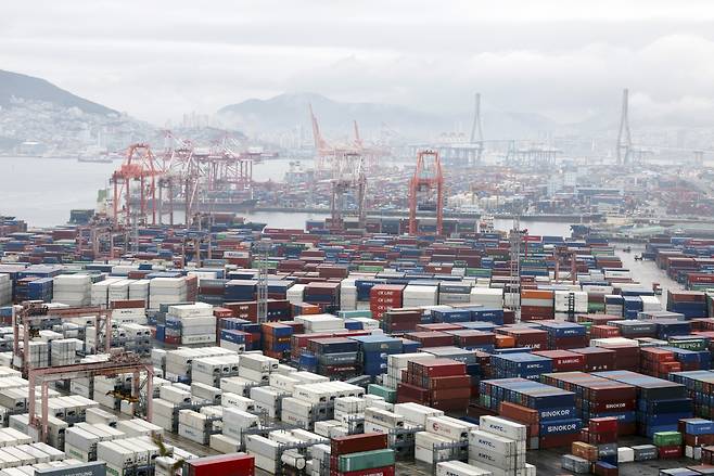 Containers for exports and imports are stacked at a pier in Busan, country's largest port city, Sunday. (Yonhap)