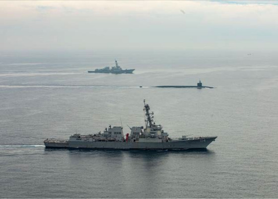 The nuclear-capable USS Kentucky ballistic missile submarine sails between two warships as it arrives in Busan on Tuesday afternoon. [UNITED STATES FORCES KOREA]