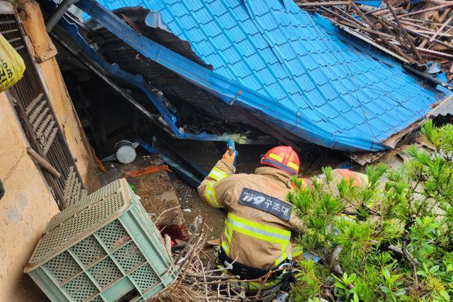 집중호우가 쏟아진 이달 15일 경북 문경시 산북면 가좌리에서 한 주택이 돌과 흙에 파묻히고 파손돼 소방관들이 현장을 수습하고 있다. 경북소방본부 제공