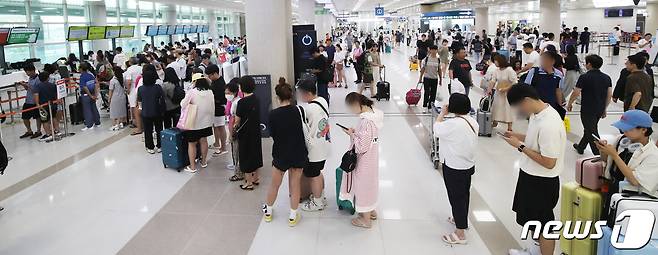 제6호 태풍 카눈이 북상 중인 9일 오전 제주국제공항에서 결항편 승객들이 대체편을 구하기 위해 항공사 안내 데스크 앞에 길게 줄을 서 대기하고 있다. 이날 오전 9시 기준 사전결항을 포함해 제주공항에서 69편(국내선 도착 31편·출발30편,국제선 도착 4편·출발 4편)의 운항이 취소됐다. 2023.8.9/뉴스1 ⓒ News1 오현지 기자