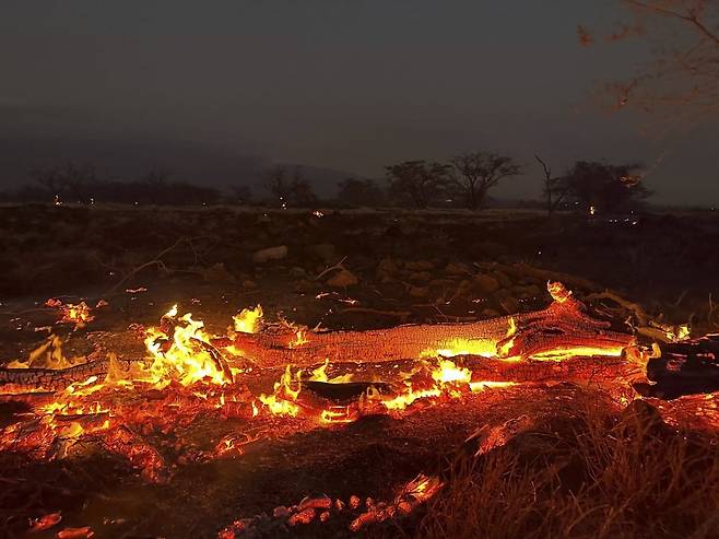 A wildfire burns in Kihei, Hawaii early Thursday, Aug. 10, 2023. Thousands of residents raced to escape homes on Maui as blazes swept across the island, destroying parts of a centuries-old town in one of the deadliest U.S. wildfires in recent years.  (AP Photo/Ty O‘Neil)