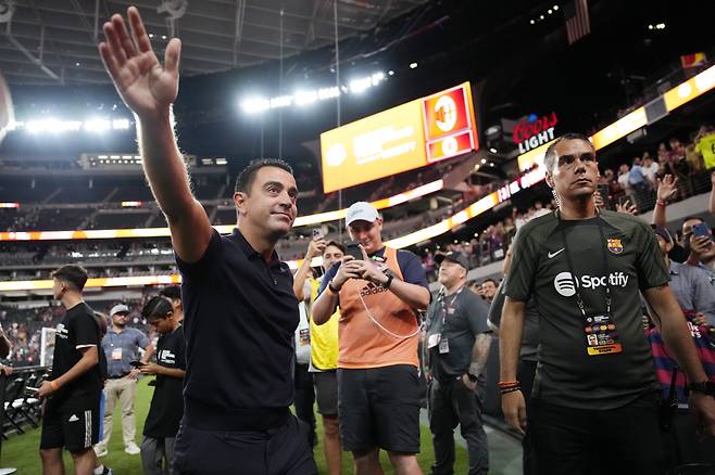 FC Barcelona coach Xavi Hernandez motions as he walks off the field after a Champions Tour soccer match against AC Milan, Tuesday, Aug. 1, 2023, in Las Vegas. (AP Photo/John Locher)