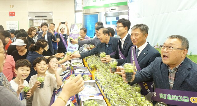 16일 대전원예농협 하나로마트에서 열린 포도데이 행사에서 참가자들이 지역주민과 소비자에게 컵포도를 나눠주고 있다.