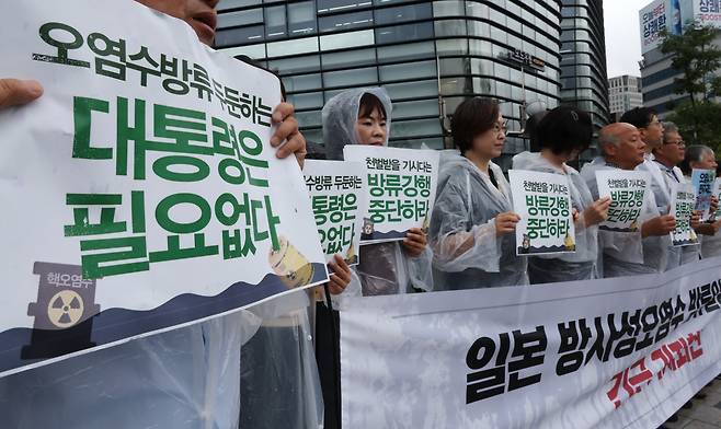 Members of civic groups hold a press conference in front of the Japanese Embassy in Seoul, criticizing President Yoon Suk Yeol for "siding with" Japan's plan to release the wastewater from the wrecked Fukushima Daiichi nuclear power plant into the sea, on Wednesday. Yonhap