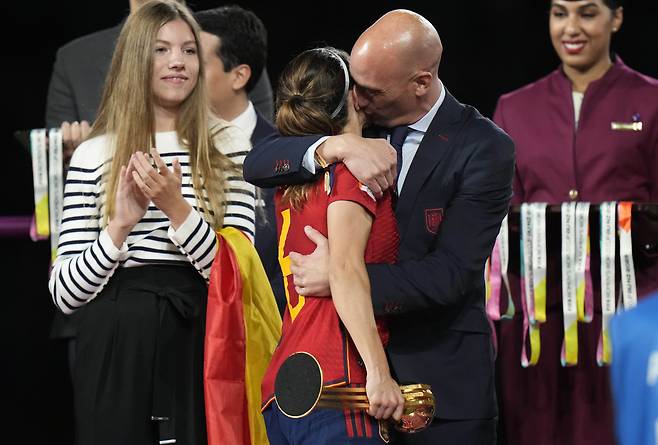 FILE - President of Spain's soccer federation, Luis Rubiales, right, hugs Spain's Aitana Bonmati on the podium following Spain's win in the final of Women's World Cup soccer against England at Stadium Australia in Sydney, Australia, Sunday, Aug. 20, 2023.The kiss by Luis Rubiales has unleashed a storm of fury over gender equality that almost marred the unprecedented victory but now looks set to go down as a milestone in both Spanish soccer history but also in women's rights. (AP Photo/Alessandra Tarantino, file) FILE PHOTO