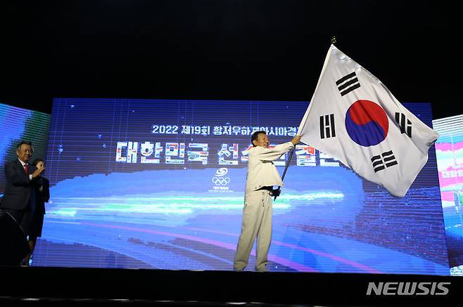 [서울=뉴시스] 고승민 기자 = 12일 서울 올림픽공원 올림픽홀에서 열린 2022 항저우 아시안게임 선수단 결단식에서 최윤 선수단장이 태극기를 흔들고 있다. 2023.09.12. kkssmm99@newsis.com