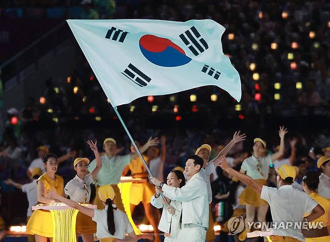 대한민국 기수 구본길-김서영 (항저우=연합뉴스) 홍해인 기자 = 23일 오후 중국 항저우 올림픽 스포츠센터 스타디움에서 열린 2022 항저우 아시안게임 개회식에서 대한민국 선수단 기수 구본길(펜싱)과 김서영(수영)이 태극기를 흔들며 입장하고 있다. 2023.9.23 hihong@yna.co.kr