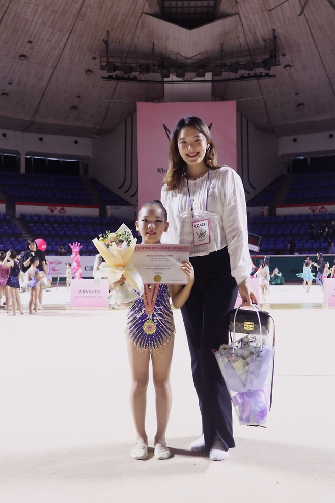 세종 국가대표 스포츠클럽에서 어린이들에 리듬체조를 가르치고 있는 전 리듬체조 국가대표 천송이 코치가 이지유(대전외국인학교 2학년) 학생과 24일 대회 종료 후 기념촬영을 하고 있다. 사진제공 | (주)국대.