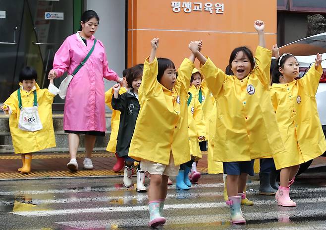 지난달 15일 오전 대구 수성대 캠퍼스에서 열린 '제12회 숲유치원·유아숲체험원 전국대회'에 참가한 어린이들이 선생님과 함께 손을 들고 횡단보도를 건너고 있다. /뉴스1