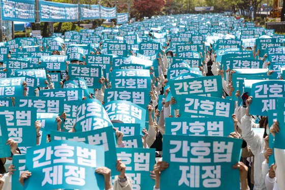 대한간호협회와 시민단체 회원들이 국회 본회의를 하루 앞둔 지난 4월 12일 서울 여의도 국회 앞 의사당대로에서 열린 간호법 국회 통과 촉구 수요한마당에서 '간호법 제정' 피켓을 들어 보이고 있다. 뉴스1