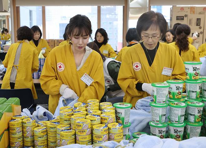 15일 서울 중구 대한적십자사 서울사무소에서 열린 연말 이웃 돕기 적십자 '2023 사랑의 선물' 제작 행사에서 한동훈 법무부 장관의 부인 진은정 변호사 등 국무위원 부인들이 선물을 포장하고 있다. [연합]