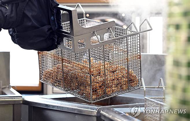 요리하는 급식 로봇 첫 공개 (서울=연합뉴스) 김인철 기자 = 22일 오전 서울 성북구 숭곡중학교 급식실에서 급식 로봇이 조리를 하고 있다.2023.11.22 [공동취재] yatoya@yna.co.kr