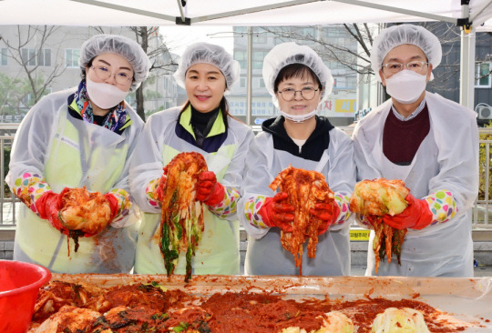 서울사이버대 통일안보북한학과 이지영(왼쪽부터) 교수, 서울사이버대 이은주 총장, 강북구 이순희 구청장, 민주평통 강북구협의회 김준호 회장이 김장나누기 행사에서 김치를 답고 있다. 서울사이버대 제공