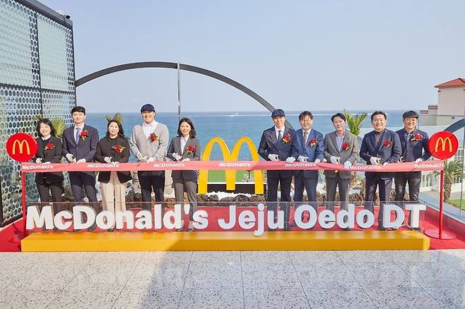 한국맥도날드 임직원들과 관계자들이 지난 23일 ‘제주외도DT점’ 오픈을 기념해 3층 루프탑 공간에서 테이프 커팅식을 진행하고 있다. 왼쪽에서 다섯 번째 한국맥도날드 김기원 대표이사.(사진=맥도날드 제공) *재판매 및 DB 금지