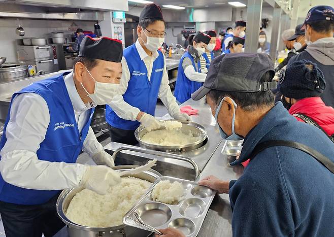 한종희 삼성전자 부회장(왼쪽) 등 임직원들이 지난 6일 성남시 안나의 집에서 배식 봉사를 하고 있다.